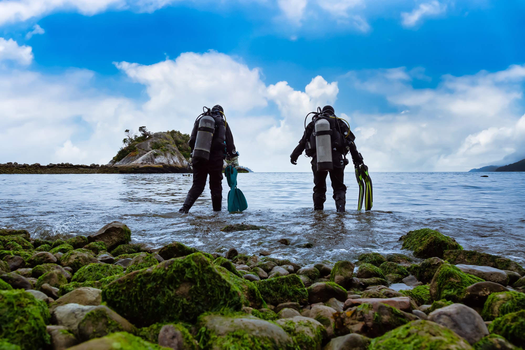 Scuba Diver getting ready to go diving at Whytecliff Park. Blue Sky Cloudy Day